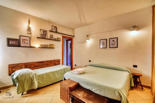 a bedroom with two beds and a window at InCorteDaFabio Design flat with Bikes in Caronno Pertusella