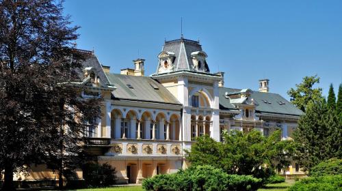 a large building with a clock tower on top of it at Zámek Světlá nad Sázavou in Světlá nad Sázavou