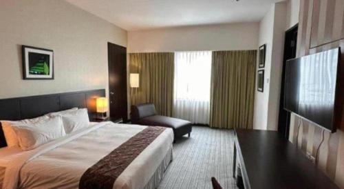 Кровать или кровати в номере RH Hotel Sibu
