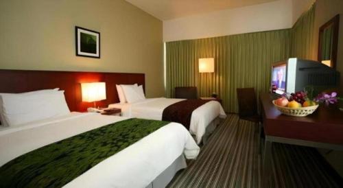 Кровать или кровати в номере RH Hotel Sibu