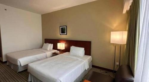 Кровать или кровати в номере RH Hotel Sibu