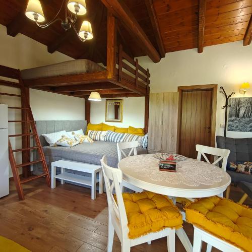a living room with a bed and a table and chairs at Eden Stay in Edessa