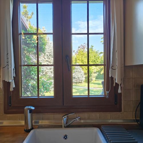 a kitchen with a sink and a window above it at Eden Stay in Edessa