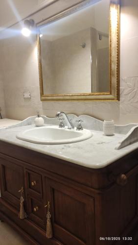 a bathroom with a sink and a mirror at Le Scalelle B&B in Scorpeto
