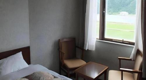 Postel nebo postele na pokoji v ubytování Sento Otani Hotel