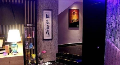 a room with a fireplace and paintings on the wall at Rock & Roll Hotel Klang in Klang