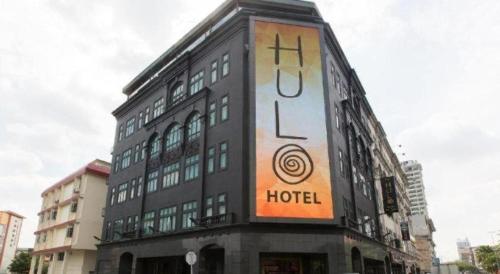a building with a sign on the side of it at The Hulo Hotel & Gallery in Kuala Lumpur