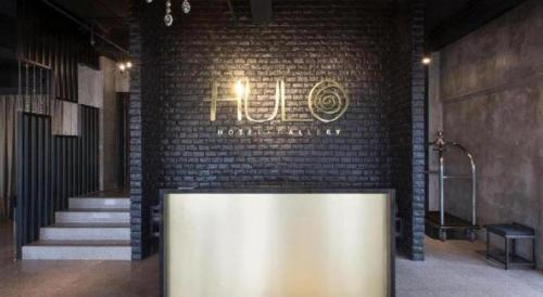 a brick wall with a sign that reads hotel at The Hulo Hotel & Gallery in Kuala Lumpur