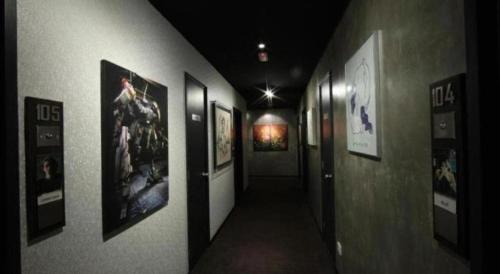 a hallway with pictures on the walls of a building at The Hulo Hotel & Gallery in Kuala Lumpur