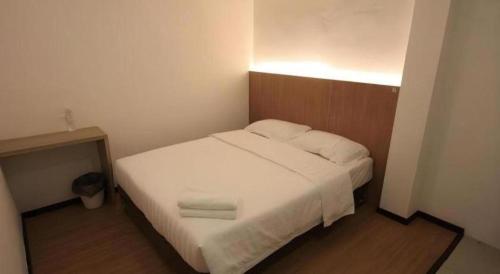 a bedroom with a bed with white sheets and pillows at Place2stay @ Campus Hub in Kuching