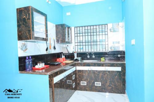 a kitchen with a sink and a mirror at Spacious Family Space Near Serenity Beach in Puducherry
