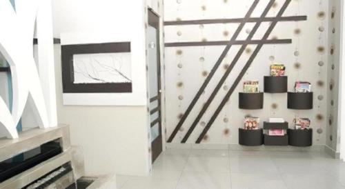 a room with a staircase with a shelf of books at e Hotel in Melaka