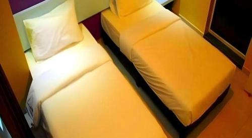 Кровать или кровати в номере Cappuccino Hotel @ Mount Austin