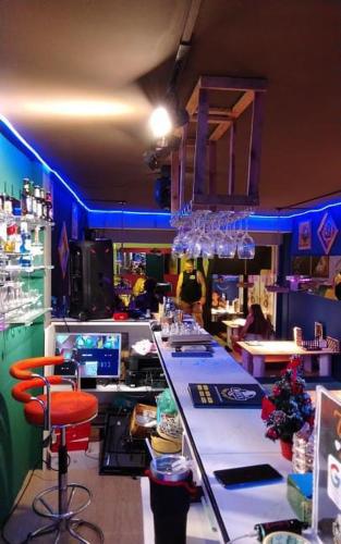 a bar in a restaurant with a counter and a bar stool at RoXx Social Hostel in Bangkok