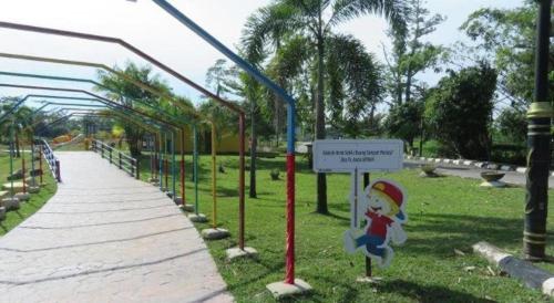 a park with a santa claus sign in the grass at PAHANG REST HOUSE @ BERA in Temerloh