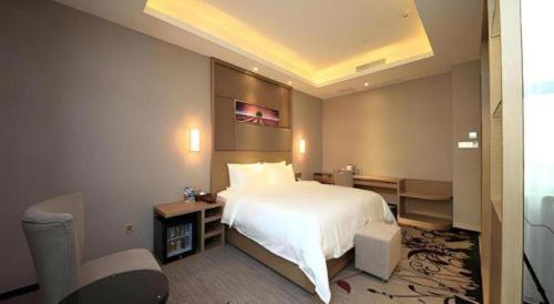 Ένα ή περισσότερα κρεβάτια σε δωμάτιο στο Shenzhen Lavande Hotel Airport Terminal Branch