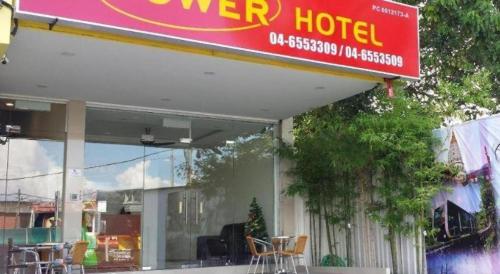 a sign for a hotel with chairs in front of it at Power Hotel in Georgetown