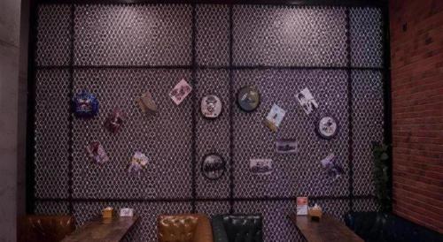 a wall with a bunch of plates on it at James Joyce Coffetel·Shijiazhuang Economic and Technological Development Zone Chuangye Road in Shijiazhuang