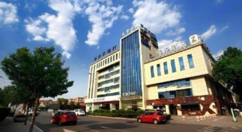 a large building with cars parked in front of it at Zmax Changzhi Bayi Square in Changzhi