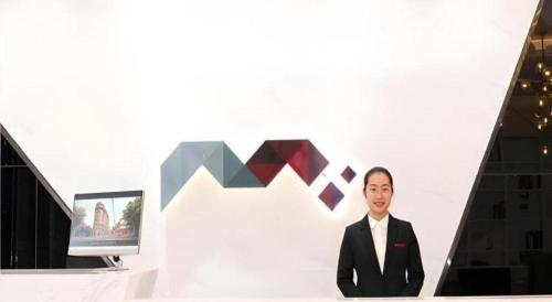 TV a/nebo společenská místnost v ubytování Borrman Hotel Xiamen Xiang'an Maxiang