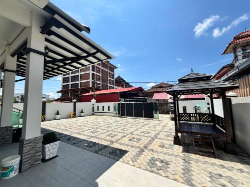 a patio with a gazebo in the middle of a building at Danish Villa in Kota Bharu