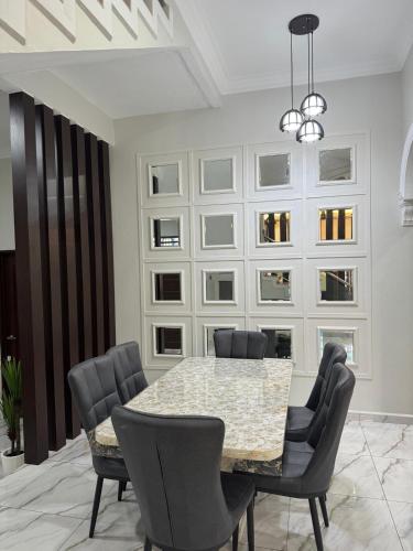 a dining room with a table and chairs at Danish Villa in Kota Bharu
