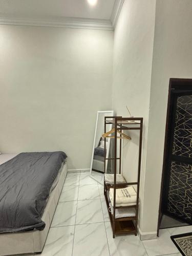 a bedroom with a bed and a mirror at Danish Villa in Kota Bharu