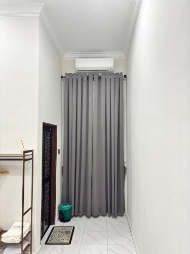 a bathroom with a shower curtain in a room at Danish Villa in Kota Bharu