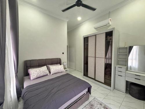 a bedroom with a bed and a ceiling fan at Danish Villa in Kota Bharu