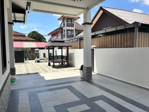 a courtyard of a house with a gazebo at Danish Villa in Kota Bharu