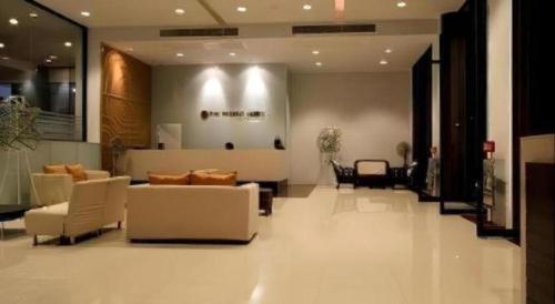 a lobby with couches and chairs in a building at The Regent Ubon in Ubon Ratchathani