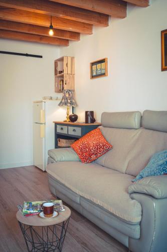 a living room with a couch and a table at Le Petit Gite du Roy in Courlay