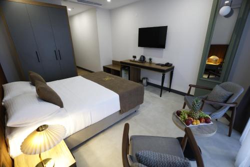 a bedroom with a bed and a table and chairs at Gezgin Hotel in Edirne