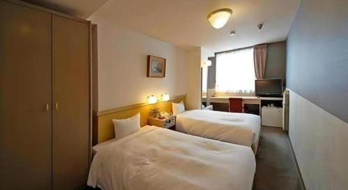Ένα ή περισσότερα κρεβάτια σε δωμάτιο στο Hotel Riverge Akebono