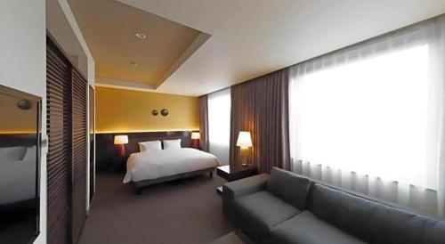 Ένα ή περισσότερα κρεβάτια σε δωμάτιο στο Hotel Riverge Akebono