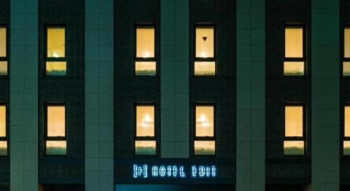 a tall building with lit windows at night at Hotel Edit Yokohama in Yokohama