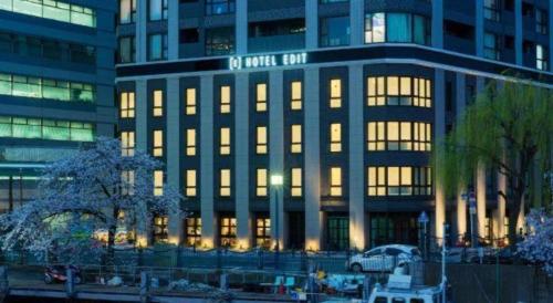 a large building with lights on in a city at Hotel Edit Yokohama in Yokohama