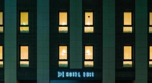 a tall building with lit windows at night at Hotel Edit Yokohama in Yokohama