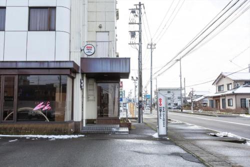 an empty street with a store on the side of a building at Tabist Hotel New Osamura Sabae in Fukui