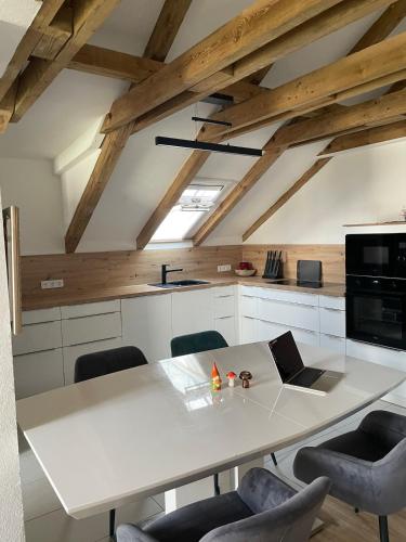 a kitchen with a large white table and chairs at Ferienwohnung in Ansbach-Elpersdorf in Ansbach