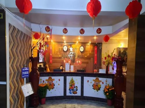 a restaurant with red balloons hanging above a counter at RUBY HOTEL in Cà Mau