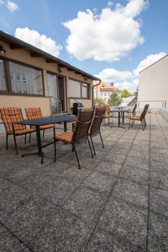 a group of chairs and a table on a patio at Penzion Růže in Humpolec