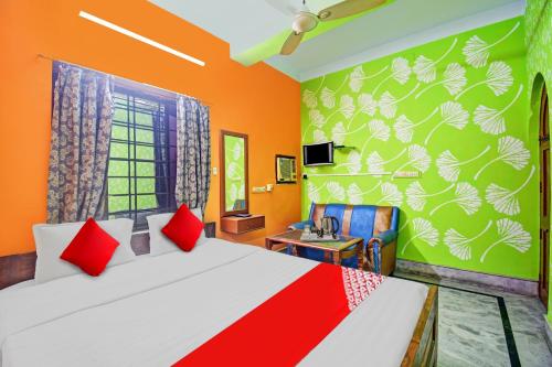 a bedroom with a large bed with red pillows at SPOT ON Hotel Royal in Jangipur