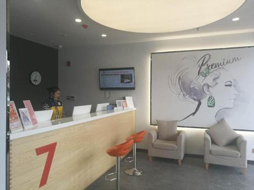 a person standing at a counter in a salon at 7 Days Premium Yancheng Dafeng Zhongjiao Meilu City in Yancheng