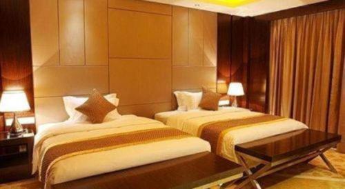 Ένα ή περισσότερα κρεβάτια σε δωμάτιο στο Santavan Hotel Shenzhen Guangming