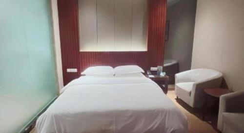 Ένα ή περισσότερα κρεβάτια σε δωμάτιο στο Santavan Hotel Shenzhen Guangming