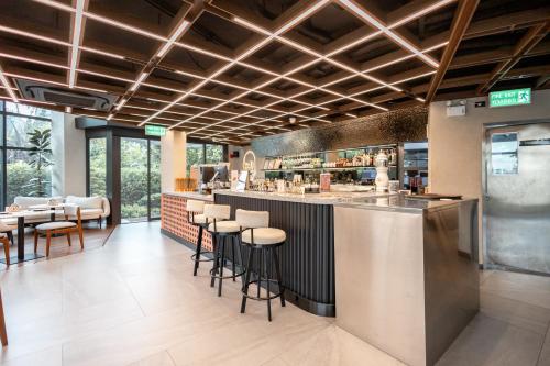 Bang SuにあるWE HOTEL RIVERFRONTのスツール付きのバーがあるレストラン