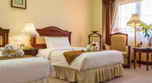 Кровать или кровати в номере Quanzhou Hotel