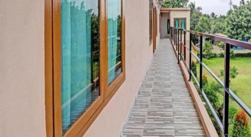a balcony of a house with glass windows at OYO 90945 Arizon Kost in Jambi