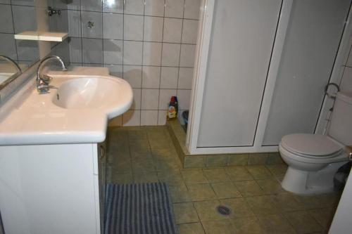 a bathroom with a sink and a toilet at Avli Guesthouse 